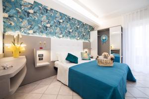 A bed or beds in a room at Viva Beach Hotel