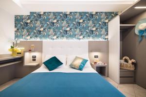 A bed or beds in a room at Viva Beach Hotel