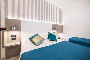A bed or beds in a room at Viva Beach Hotel