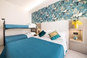 A bed or beds in a room at Viva Beach Hotel
