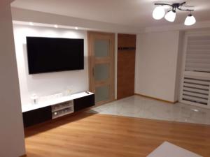 a living room with a flat screen tv on a wall at Mieszkanie z niezależnym wejściem in Ochotnica Górna
