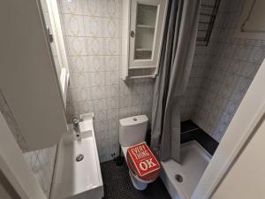 a small bathroom with a toilet and a sink at STUDIO MET FRONTAAL ZEEZICHT in Middelkerke