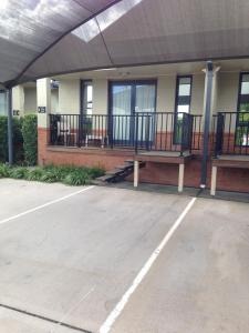 a empty parking lot in front of a building at Francis Phillip Motor Inn and The Lodge in Singleton