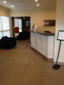 a bar in a waiting room with couches at Francis Phillip Motor Inn and The Lodge in Singleton