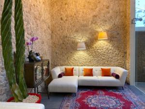 a living room with a white couch and orange pillows at Casarte Boutique Hotel in Playa del Carmen