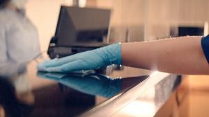 a person with blue gloves on a counter at Hotel H-Wood in Los Angeles