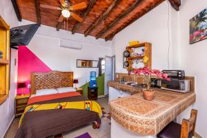 a bedroom with a bed and a sink in it at Suites de Mita - Boutique Hotel in Punta Mita