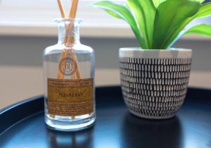 a bottle of water on a table next to a vase at City Haven Preston Apartments in Preston