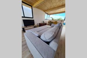 a living room with a couch and a television at Baobab House in Los Llanos de Aridane