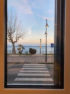 a view of a street from a window with a view of the ocean at Una Finestra sul Mare in Maiori