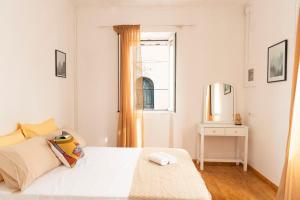 a white bedroom with a bed and a window at Archontiko ''Danae'' in Lefkimmi +56 photos