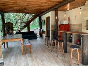 a living room with a couch and a table and chairs at Chalé Verdant in Canoinhas