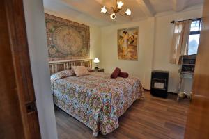 a bedroom with a bed with a colorful blanket at Majikal B&B - Sherezade in Cholula