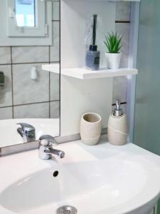 a bathroom with a sink and a mirror at Villa Sofija in Supetar