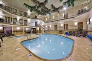 a large pool in the middle of a hotel lobby at Studio 6 - Minot, ND in Minot