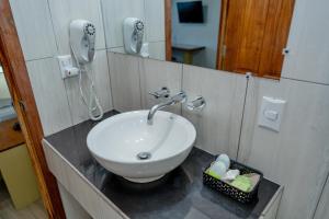 a bathroom with a white sink and a mirror at Hotel Casazul in Flores +52 photos
