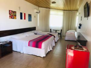 Säng eller sängar i ett rum på Hotel Fazenda Triunfo