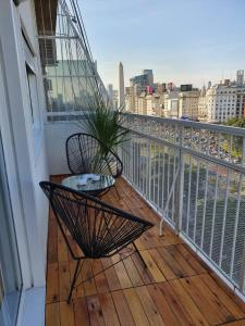 a balcony with a chair and a plant on a balcony at Obelisco Deptos in Buenos Aires