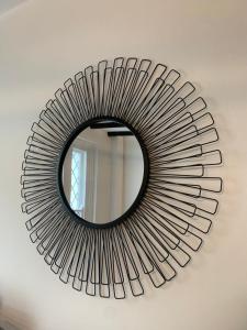 a circular mirror on a wall in a room at Number 48 in Salisbury