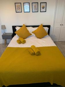 a yellow bed with two yellow slippers on it at Number 48 in Salisbury