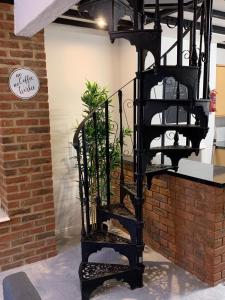a black spiral staircase next to a brick wall at Number 48 in Salisbury