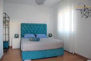 a bedroom with a blue bed and white walls at Casa do Corval in Aldeia do Mato