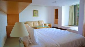 a bedroom with a large white bed and a lamp at Holiday Inn Morelia, an IHG Hotel in Morelia