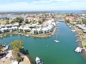 an aerial view of a marina with boats in the water at Captains Cove Waterfront Apartments in Paynesville
