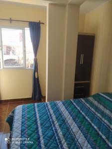 a bedroom with a bed and a window at Casa en La Viña in San Salvador de Jujuy