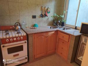 a kitchen with a stove and a sink at Casa en La Viña in San Salvador de Jujuy +8 photos