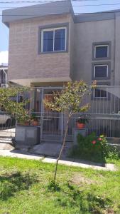 a small tree in front of a house at Casa en La Viña in San Salvador de Jujuy