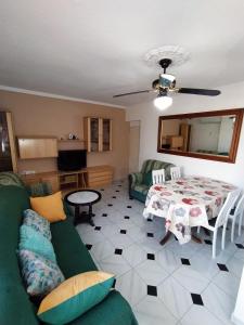 a living room with a couch and a table at Apartamento Playa de Almería - Playa del Zapillo 2 in Almería