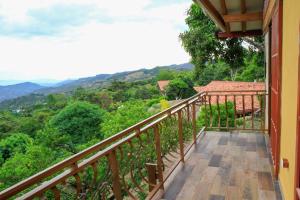 a balcony with a view of the mountains at ECOCABAÑAS SAN PEDRO in Anapoima