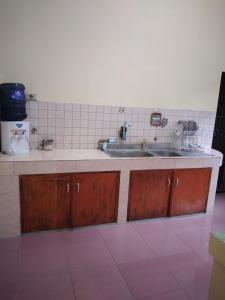 a kitchen with a sink and a counter top at RUMAH PAKSI HOMESTAY in Tanjungkarang