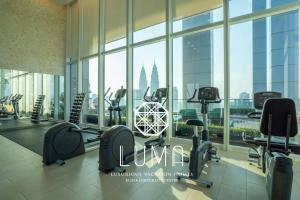 een fitnessruimte met loopbanden en fitnessapparatuur in een gebouw bij The Platinum Kuala Lumpur by LUMA in Kuala Lumpur