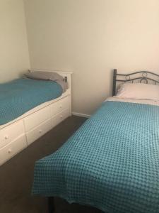 two beds in a small room with at Brand new 4br get away 5min to albury city in Lavington