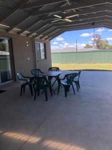 a picnic table and chairs on a patio at Brand new 4br get away 5min to albury city in Lavington