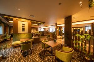 a lobby of a hotel with chairs and tables at Hotel Keihan Tenmabashi in Osaka
