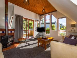 a living room with a couch and a fireplace at The Gingerbread House - Ohakune in Ohakune