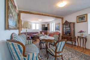 a living room with chairs and a table at Historic Old Town apartment with the best view in town in Poreč