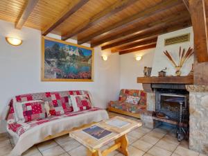 a living room with a couch and a fireplace at Modern Holiday Home in Montagny with Balcony in Montagny