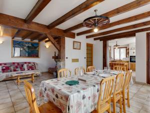 a kitchen and living room with a table and chairs at Modern Holiday Home in Montagny with Balcony in Montagny