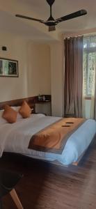 a bedroom with a large bed with a ceiling at BANALARI PINE INN in Shillong