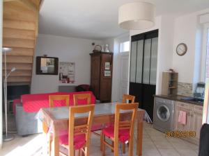 a kitchen and dining room with a table and chairs at Comfy holiday home in Crux La Ville with fenced garden in Crux-la-Ville