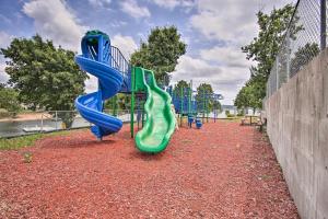a playground with blue and green slides in a park at Lakefront Afton Cottage with Deck Walk to Boat Ramp in Monkey Island