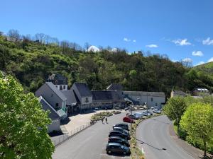 a town with cars parked on the side of a street at Villa in Saint-Nectaire near Ski Slopes in Saint-Nectaire