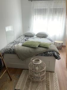 een slaapkamer met een bed met een raam en een mand bij Le cocon in Guebwiller