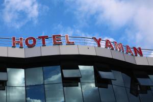 a sign on the top of a hotel yamarin building at Hotel Yaman in Eberswalde