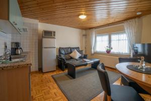 a kitchen and living room with a couch and a refrigerator at Ferienwohnungen Haus Cramer in Winterberg