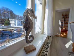 a statue of a seahorse in a room with a window at Villa Li - Fewo 06 "Sonneninsel" in Ostseebad Sellin +18 photos